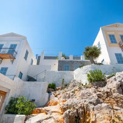 a group of buildings on top of a mountain at The Anchor House in Symi