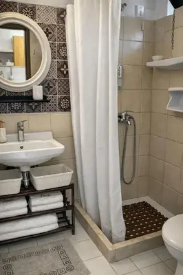 a bathroom with a shower curtain and a sink at ANGELOS STUDIOS 3-4 in Faliraki Rhodes-Upper Floor in Faliraki