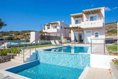 a villa with a swimming pool in front of a house at Villa Regina - Luxury and Comfort in Lachania