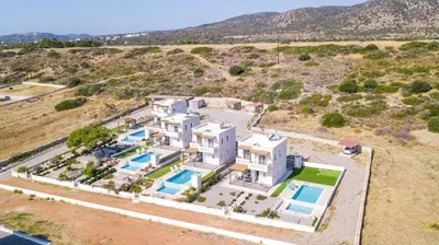 an aerial view of a large white house at Villa Regina - Double Pool Paradise in Lachania